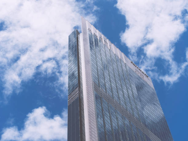 istock blue sky and clouds reflected on glass building 973075188