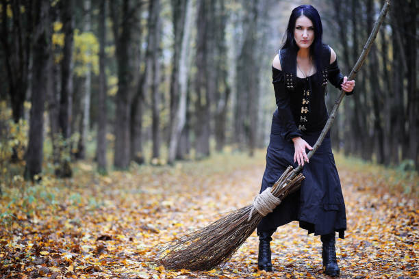istock A woman in a witch suit in a forest 973075486