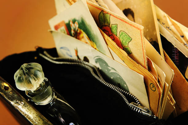 Vintage perfume, documents and postcards in open old handbag