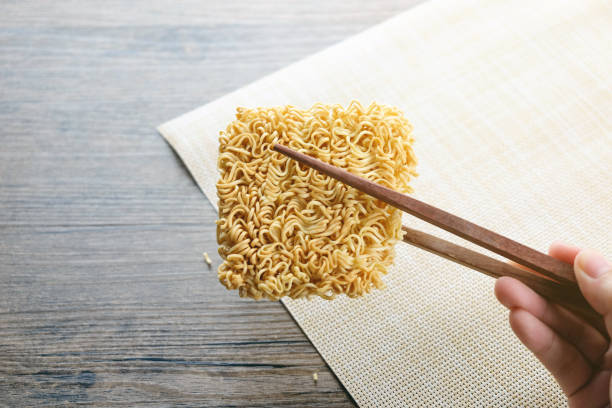 istock chopsticks and instant noodle on the wooden table 973088938