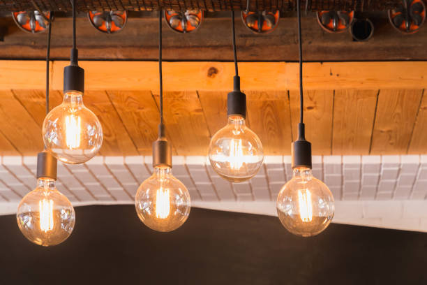 istock Decorative antique LED tungsten light bulbs hanging on ceiling. 973089450