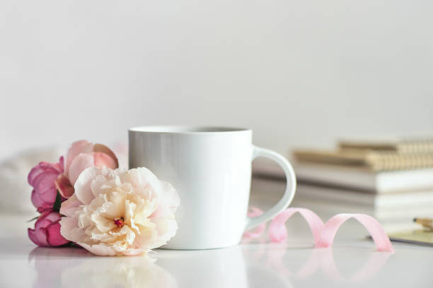 istock Cup of coffee or tea on working desk 973089524