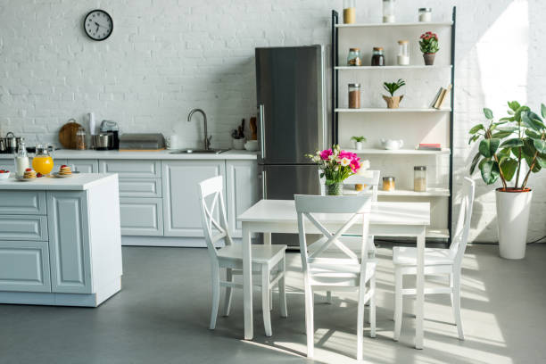 istock interior of modern light kitchen with table and chairs 973095464