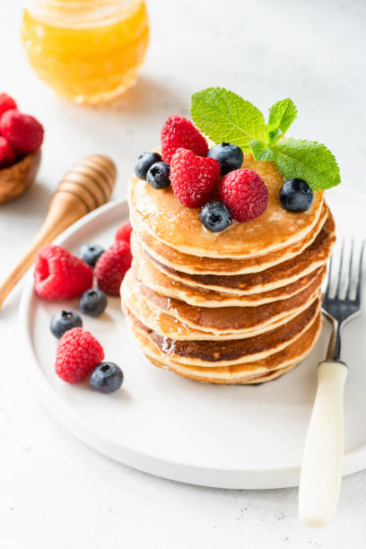 istock Pancakes with berries, honey and mint 973095892