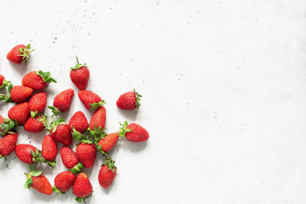 istock Fresh strawberry. Strawberries on white concrete background 973096088