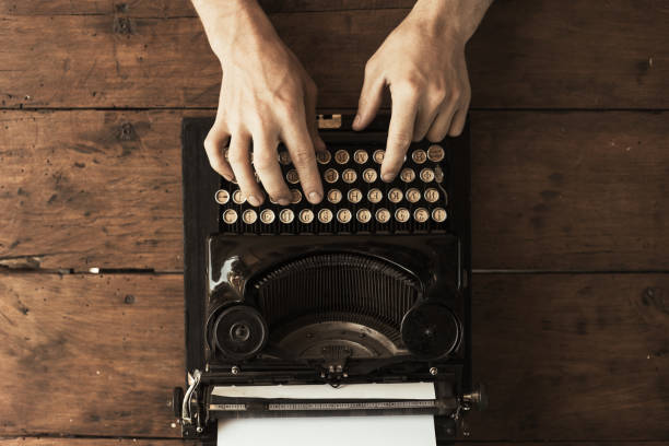 istock Young man's hands typing on an antique vintage typewriter 973096290