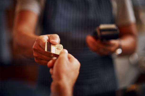 I'd like to pay with card thank you Closeup of an unrecognizable person making a payment to a barman through use of a credit card inside a beer brewery during the day credit card purchase stock pictures, royalty-free photos & images