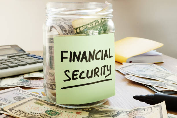 istock Financial security written on a jar with dollar banknotes. 973096838