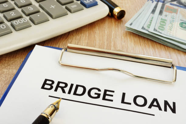 istock Bridge loan form and clipboard on a desk. 973099024