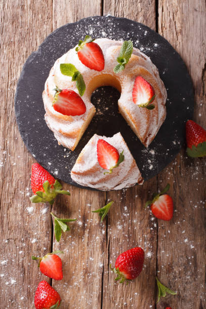 istock Pound Cake cake with mint and strawberry close-up. Vertical top view 973108756