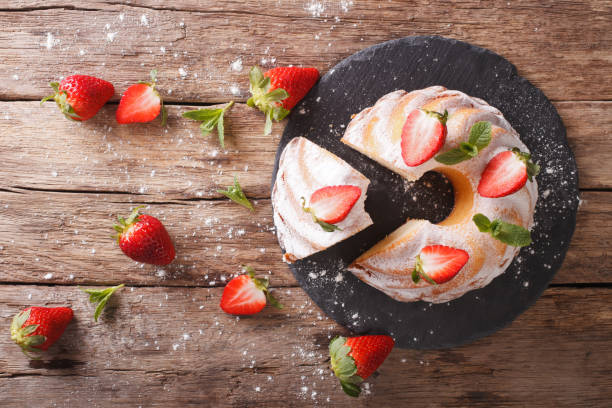 istock Vanilla biscuit cake with mint and strawberry close-up. horizontal top view 973108804