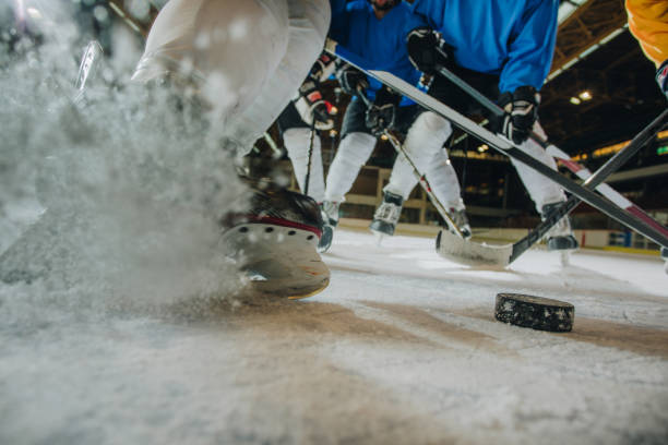 istock Unrecognizable player splashing ice during a hockey game in a rink. 973112598