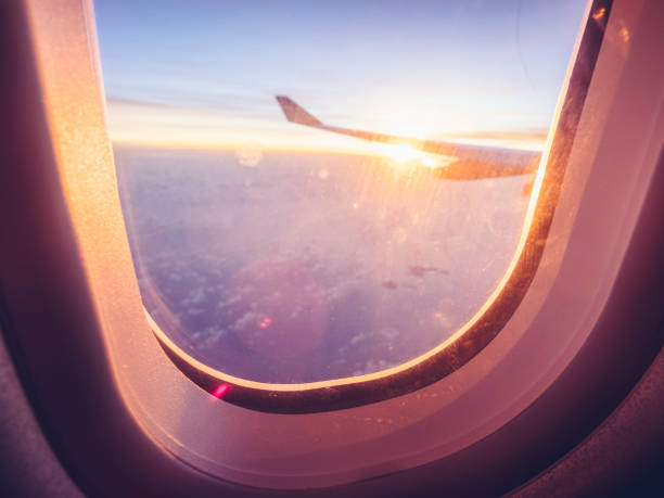 istock above clouds with aircraft wing at sunset 973112620