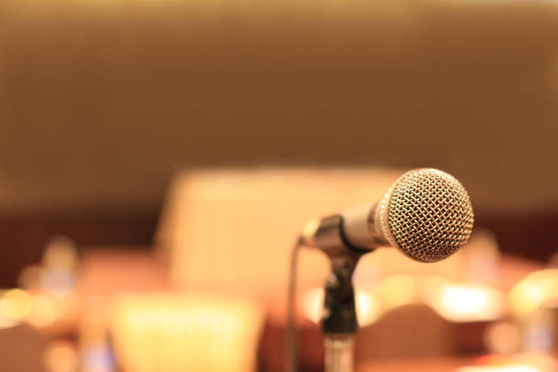 microphone in front of meeting room empty chairs before the conference