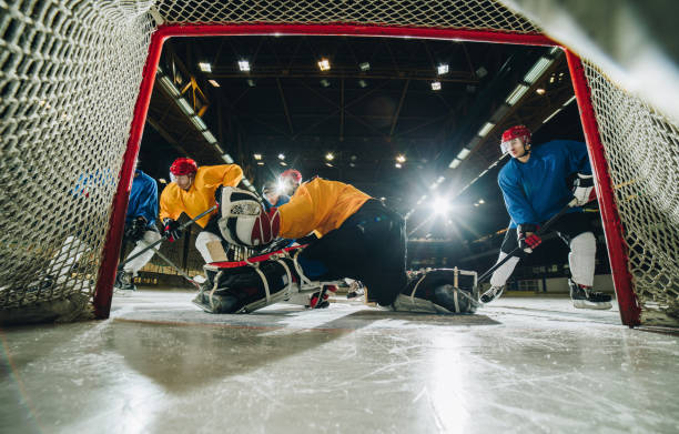 istock Determined goalie defending his goal during an ice hockey game. 973116458