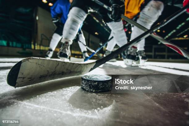 Close Up Of Ice Hockey Puck And Stick During A Match Stock Photo - Download Image Now