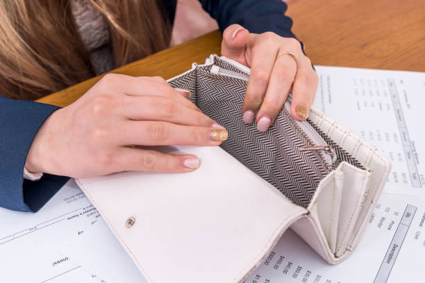 istock Female hands with empty purse and purchasing orders 973134882