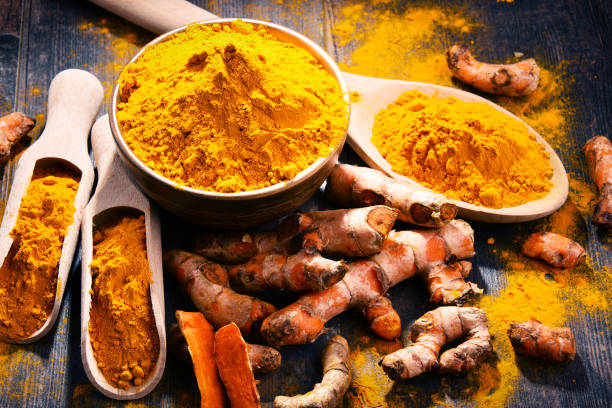istock Composition with bowl of turmeric powder on wooden table 973136966