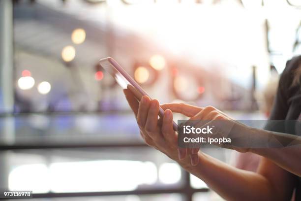 Close Up Of Womens Hands Holding Smartphone Her Watching Sms Message Email On Mobile Phone In Coffee Shop Blurred Background Stock Photo - Download Image Now