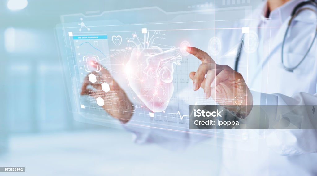 Medicine doctor and stethoscope touching icon heart and diagnostics analysis medical on modern virtual screen interface network connection. Medical technology diagnostics of heart concept Heart - Internal Organ Stock Photo
