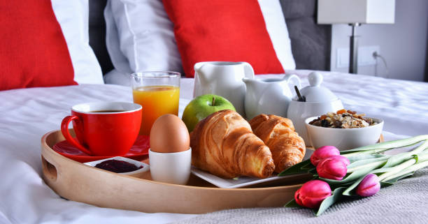 istock Breakfast on tray in bed in hotel room 973141948
