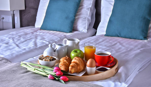 istock Breakfast on tray in bed in hotel room 973145462