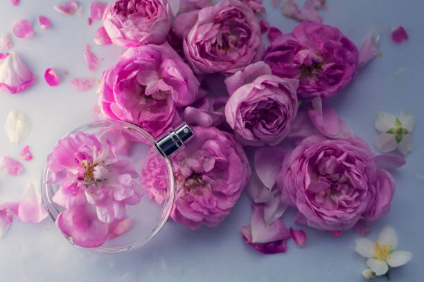 istock Female perfume with pink flowers 973162570