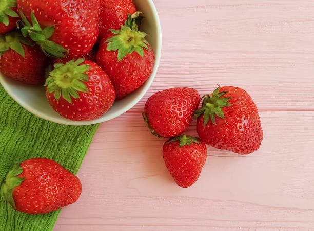 fresh strawberry on a pink wooden background