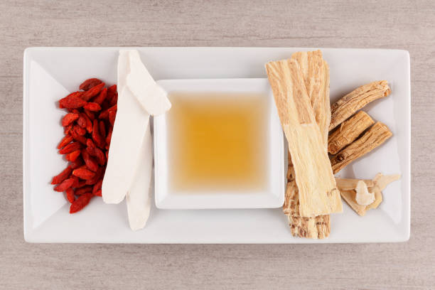 istock Different kind of Chinese herbal  and broth on gray background. 973163268