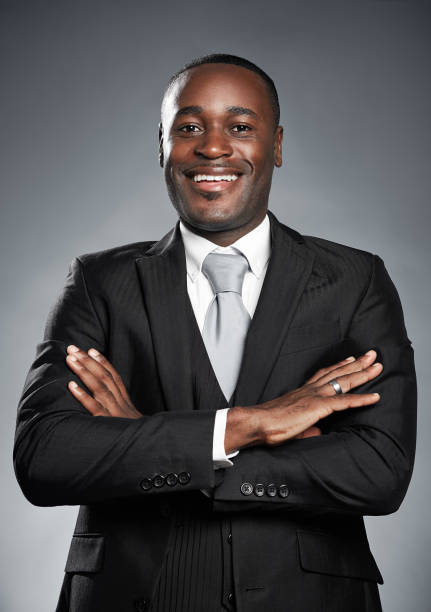 istock Handsome African-American businessman smiles with arms folded 973163438
