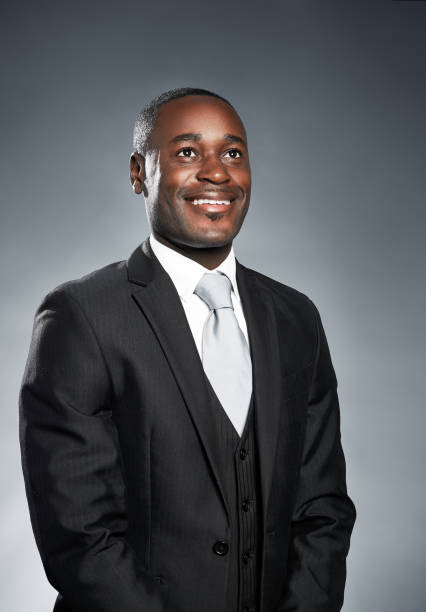 istock Handsome African-American businessman smiles looking up. 973166242