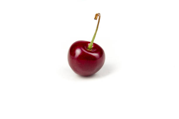 istock One Fresh ripe cheery berry in closeup on isolated white background. Berries 973166478