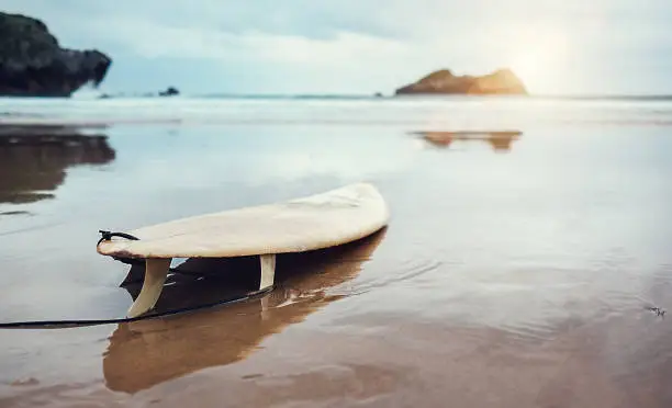 Photo of Board for surfing on deserted ocean beach