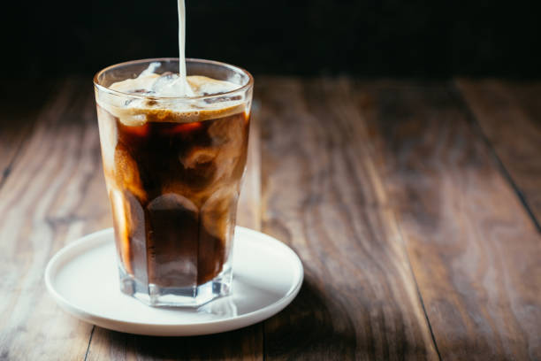 istock Pouring milk in an iced coffe 973170192