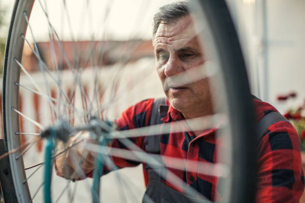 istock Senior man repairing bicycle 973170684