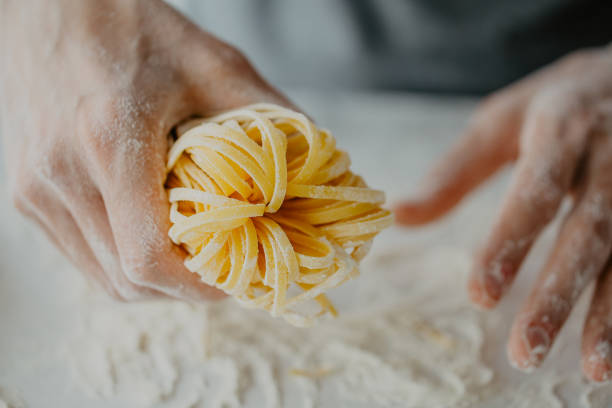 istock Chef making traditional italian homemade pasta 973180790