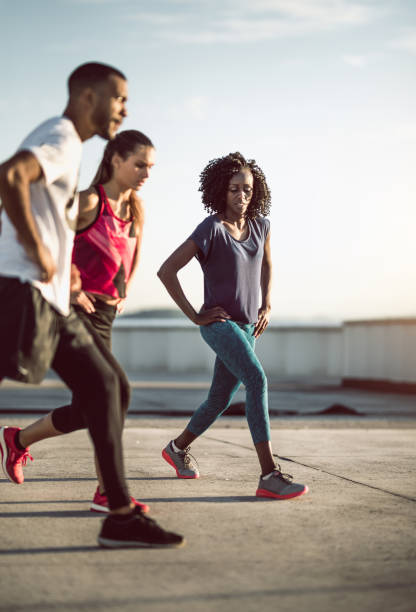 istock Small Group of Athletes Exercising Outdoors 973184648