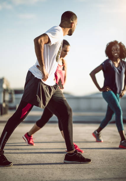 istock Small Group of Athletes Exercising Outdoors 973184654