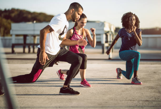 istock Small Group of Athletes Exercising Outdoors 973187276
