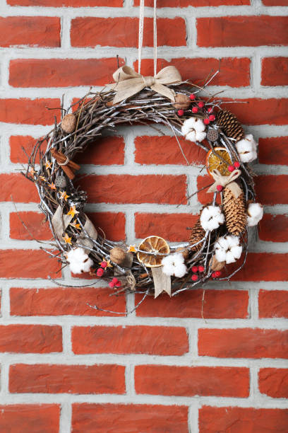 istock Christmas wreath on brick wall background 973188138