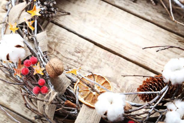 istock Christmas wreath on grey wooden table 973188204