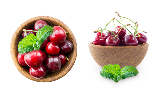 Cherry fruits with bowl on a white. Set of cherries. Fresh red cherries lay on white isolated background with copy space. Background of cherries. Ripe cherry on a white background. Cherries with copy space for text. Top view.