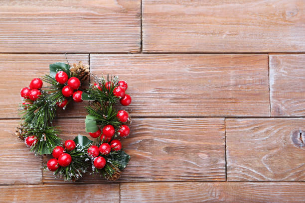 istock Christmas wreath on brown wooden table 973190600