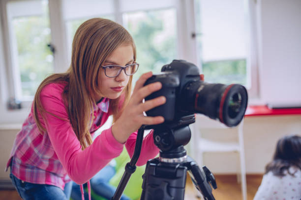 istock Cute young girl photographer 973190814