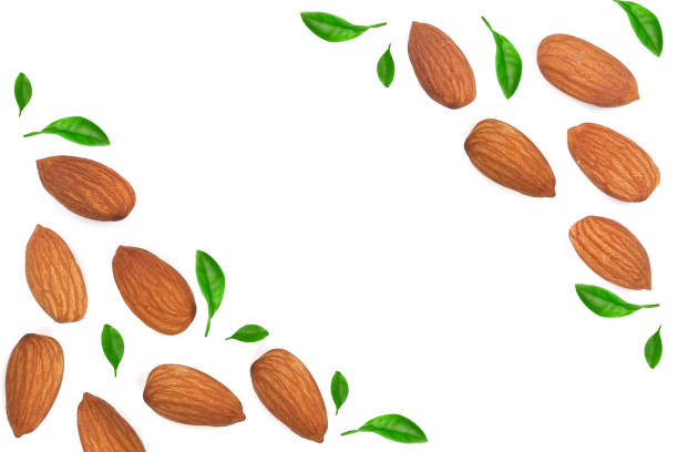 istock almonds decorated with leaves isolated on white background with copy space for your text. Top view. Flat lay pattern 973191056