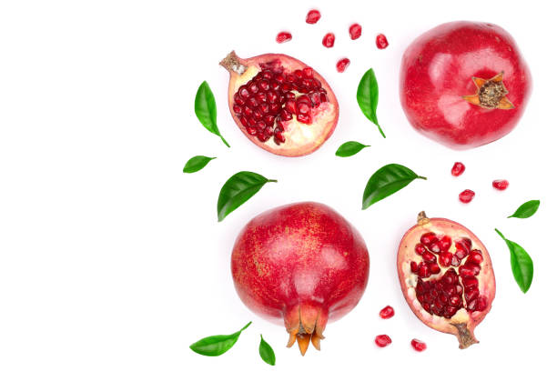 istock pomegranate with leaves isolated on white background with copy space for your text. Top view. Flat lay pattern 973191154