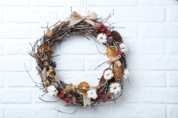 istock Christmas wreath on white brick wall background 973191368