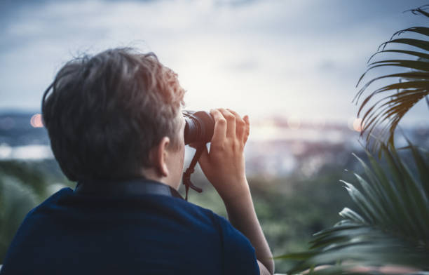 istock Teenage Boy Looking Through Binoculars 973204352