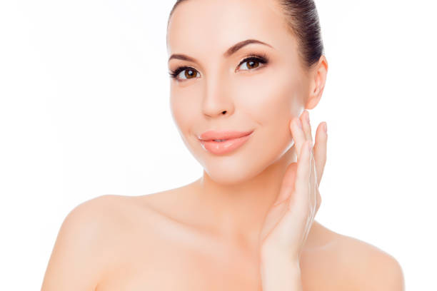 istock Fresh beautiful happy young woman touching her face 973205040