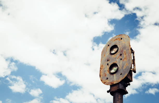Old rusty train semaphore with sky background in the old station of Zaranda, Spain